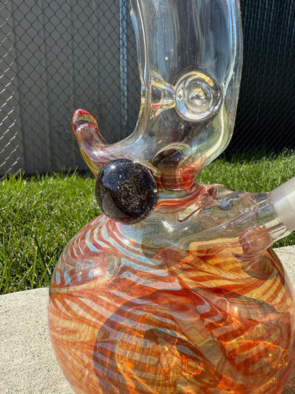Round Glass Red Spike Bubble beaker 14mm 45° showcasing intricate designs and vibrant colors on a sunny day.