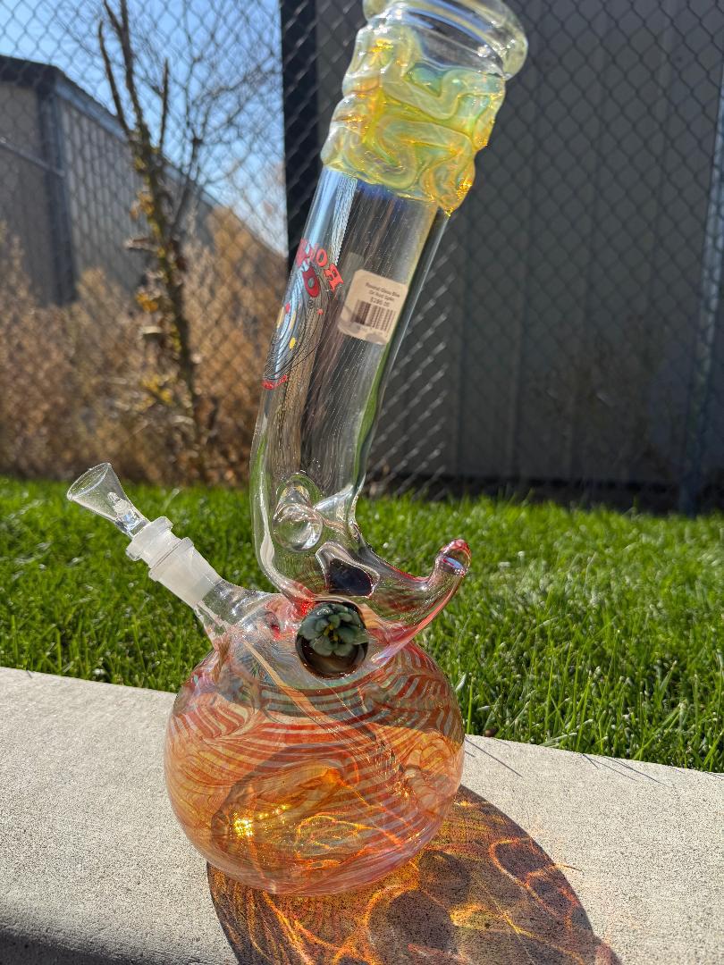 Round Glass Red Spike Bubble beaker 14mm 45° with colorful design on outdoor background.