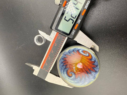 Royals Glass OG Dichoric Wig Wag XL marble measured with calipers, showcasing vibrant design and opal center.