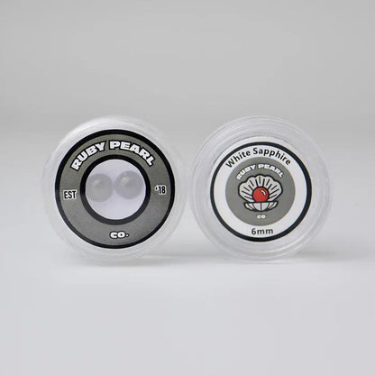 Ruby Pearl Co Terp Pearls – Ruby & Sapphire 6mm AAA Lab-Grown Gemstones (2-Pack) displayed in packaging.