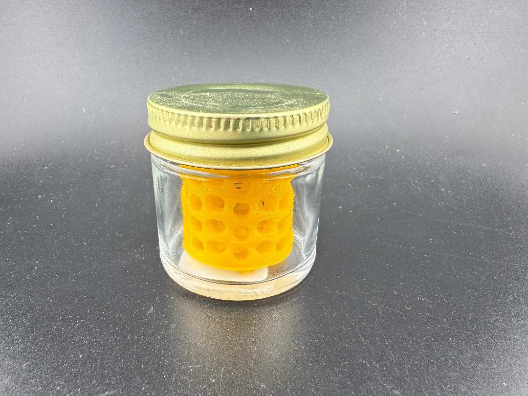 Ruby Pearl Co Pearl Jar Washing Station with an orange insert in a glass jar, designed for cleaning pearls.