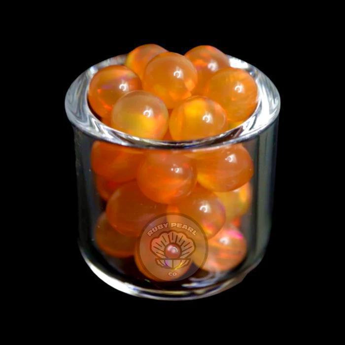 Ruby Pearl Co Terp Pearls - Opal 5mm in a glass container with vibrant orange color.