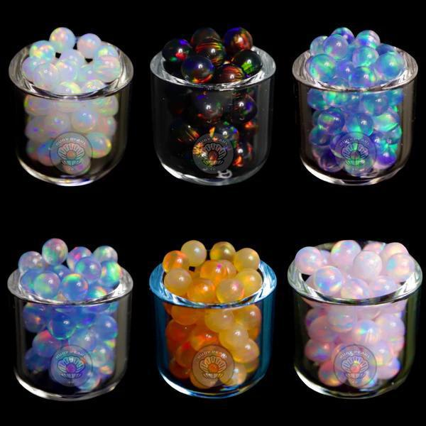 Ruby Pearl Co Terp Pearls - Opal 5mm displayed in glass jars showcasing vibrant colors.