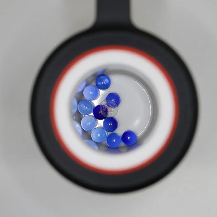 Ruby Pearl Co Terp Pearls – Ruby & Sapphire 3mm AAA Lab-Grown Gemstones (10-Pack) in view through rig lens.