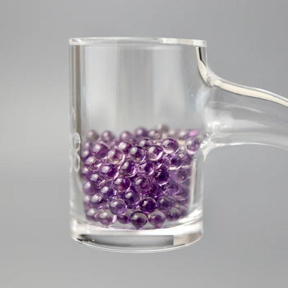 Ruby Pearl Co Terp Pearls – Ruby & Sapphire 3mm AAA Lab-Grown Gemstones (10-Pack) in a glass container.