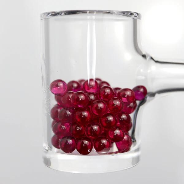 Ruby Pearl Co Terp Pearls – Ruby & Sapphire 4mm AAA Lab-Grown Gemstones (2-Pack) in a glass container.