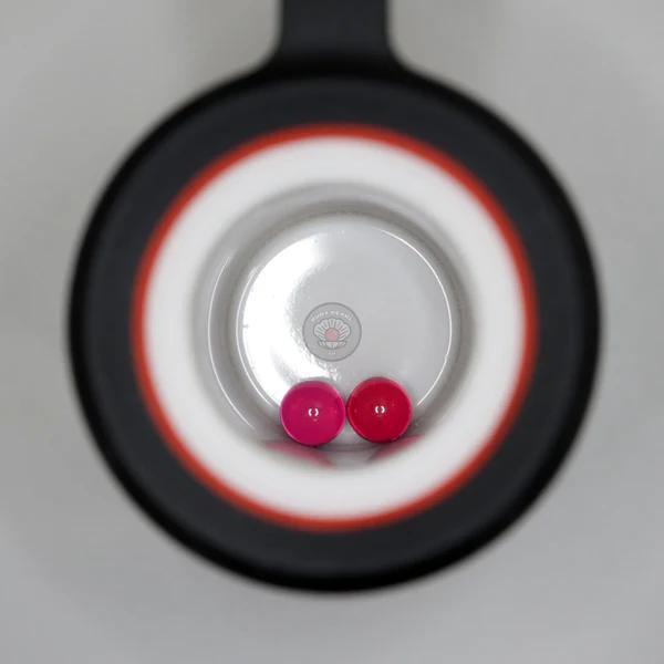 Ruby Pearl Co Terp Pearls – Ruby & Sapphire 4mm AAA Lab-Grown Gemstones (2-Pack) displayed in a black rig.