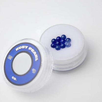 Ruby Pearl Co Terp Pearls – Ruby & Sapphire 3mm AAA Lab-Grown Gemstones (10-Pack) in a clear container.