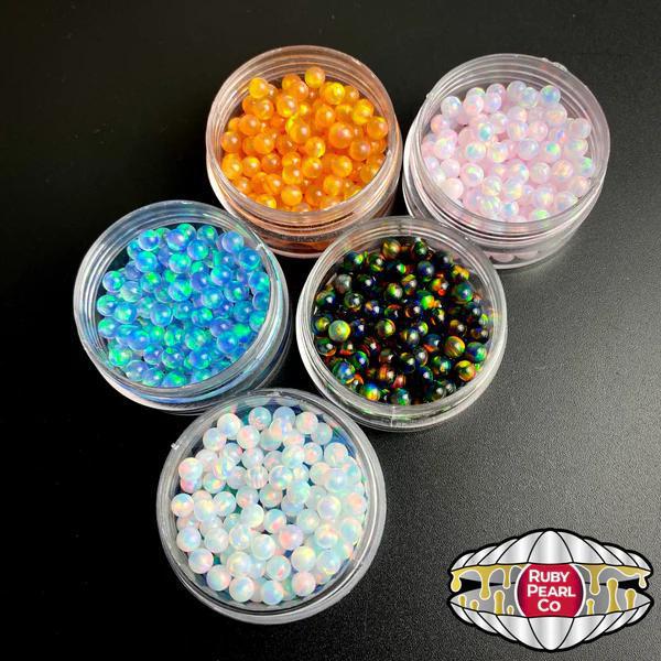 Ruby Pearl Co Terp Pearls – Opal 4mm vibrant colors in jars displayed for dabbing setups.