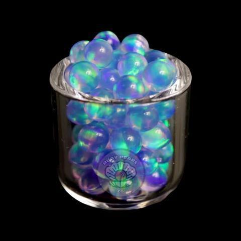 Ruby Pearl Co Terp Pearls – Opal 4mm in a glass container with vibrant colors for dabbing setups.