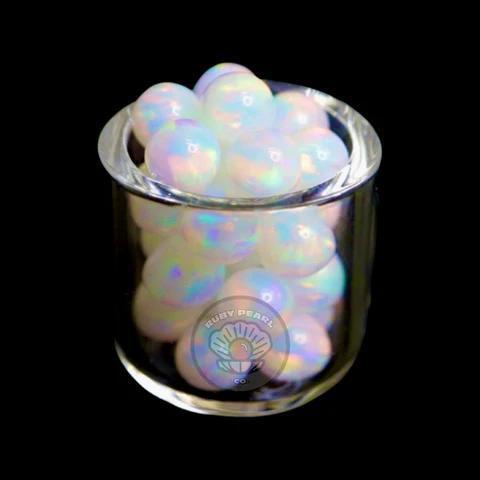 Ruby Pearl Co Terp Pearls - Opal 5mm in a clear container showcasing vibrant color play.