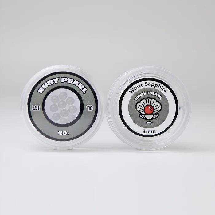 Ruby Pearl Co Terp Pearls – Ruby & Sapphire 3mm AAA Lab-Grown Gemstones (10-Pack) in clear packaging.