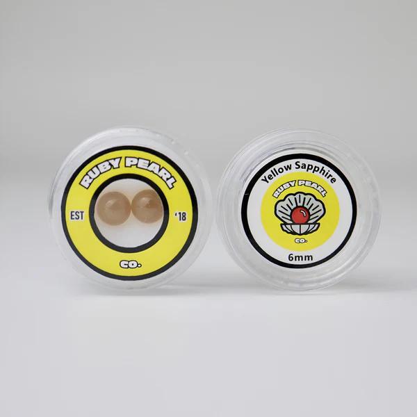 Ruby Pearl Co Terp Pearls – Ruby & Sapphire 6mm AAA Lab-Grown Gemstones (2-Pack) in packaging with labels.