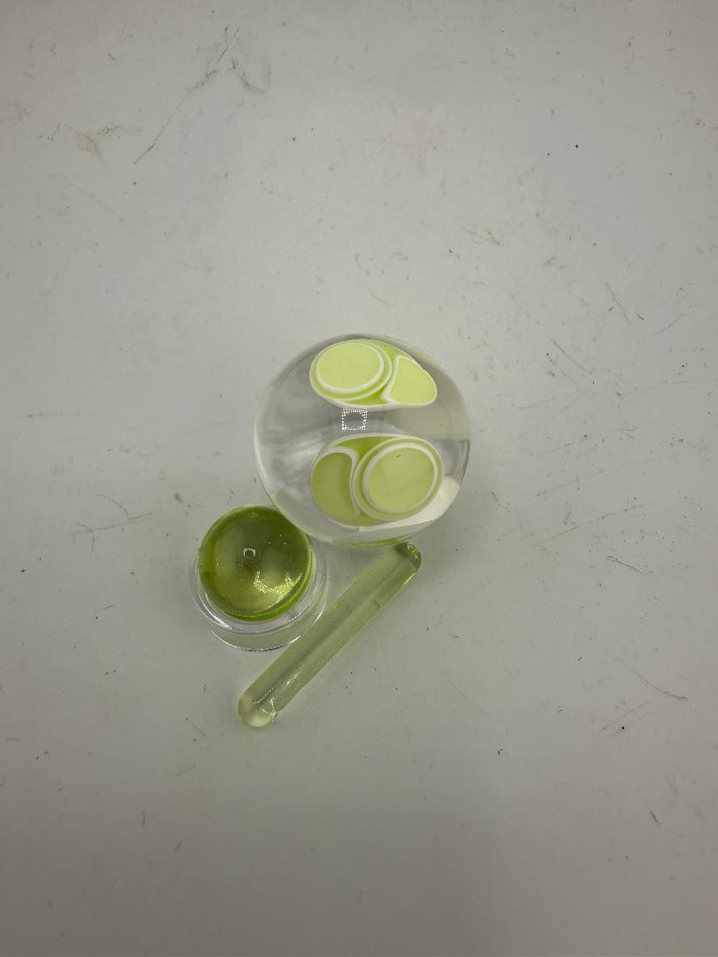 SBJ Glass Slurper Set includes a round glass slurper, dab tools, and a vibrant green concentrate container.