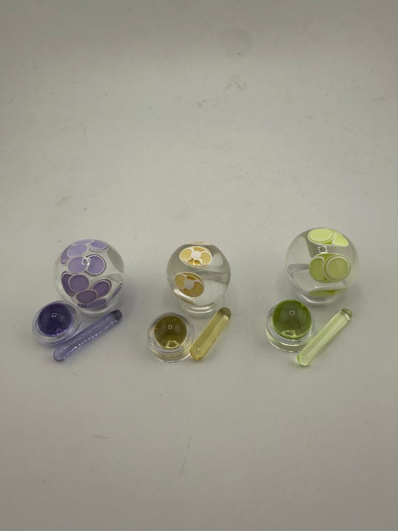 SBJ Glass Slurper Set featuring colorful glass spheres and accessories in purple, yellow, and green for optimal use.