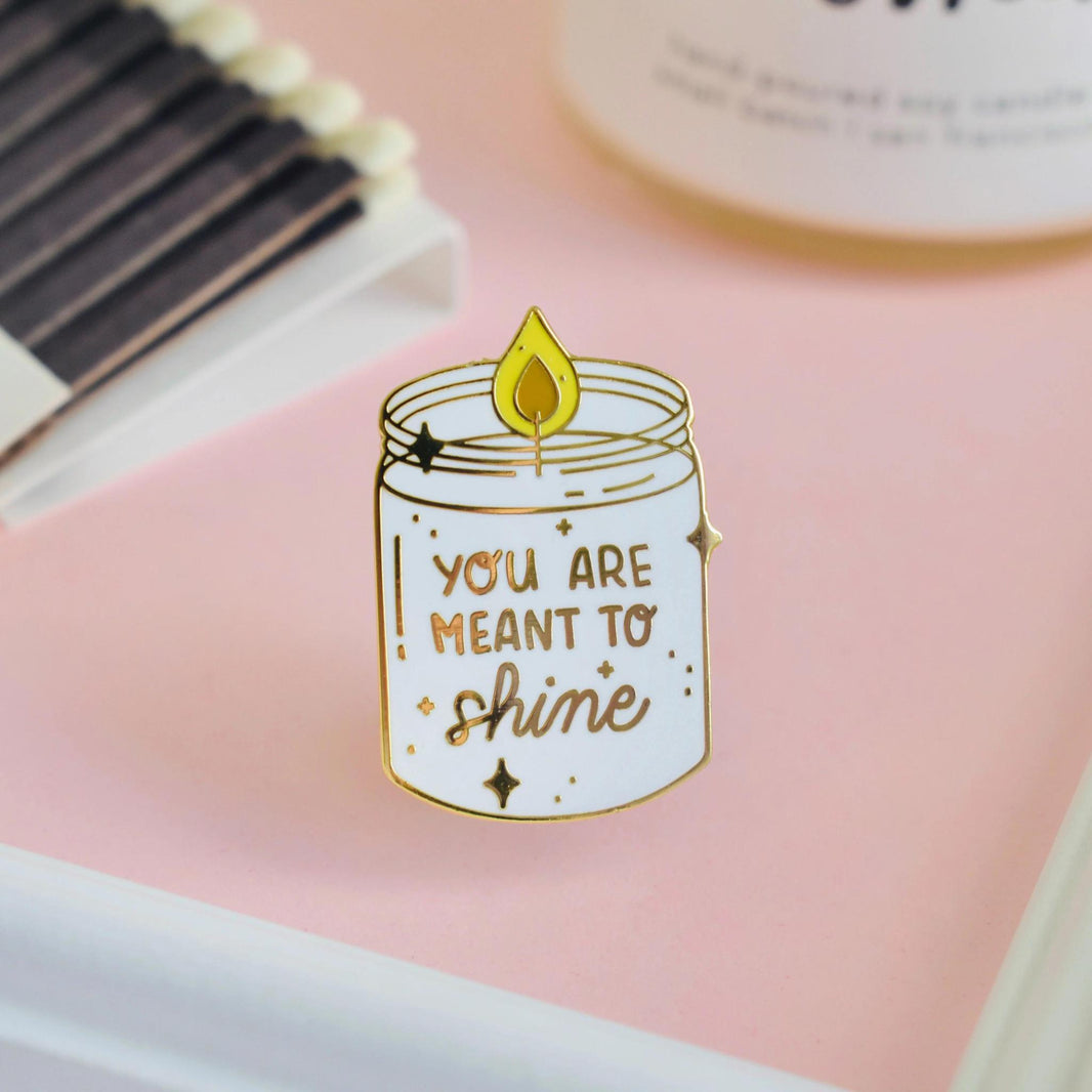 Occasionalish Enamel Pin - Shine Bright featuring a candle design with 'You Are Meant to Shine' text.