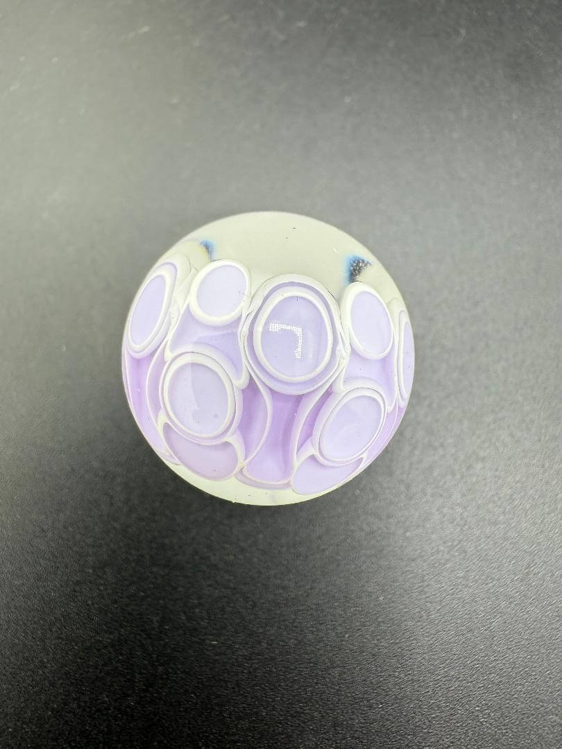 Silacious Boro Jockey (SBJ) Glass Marble Fancy Dot Stack Over Clear Approx. 1" shown from above on a dark surface.