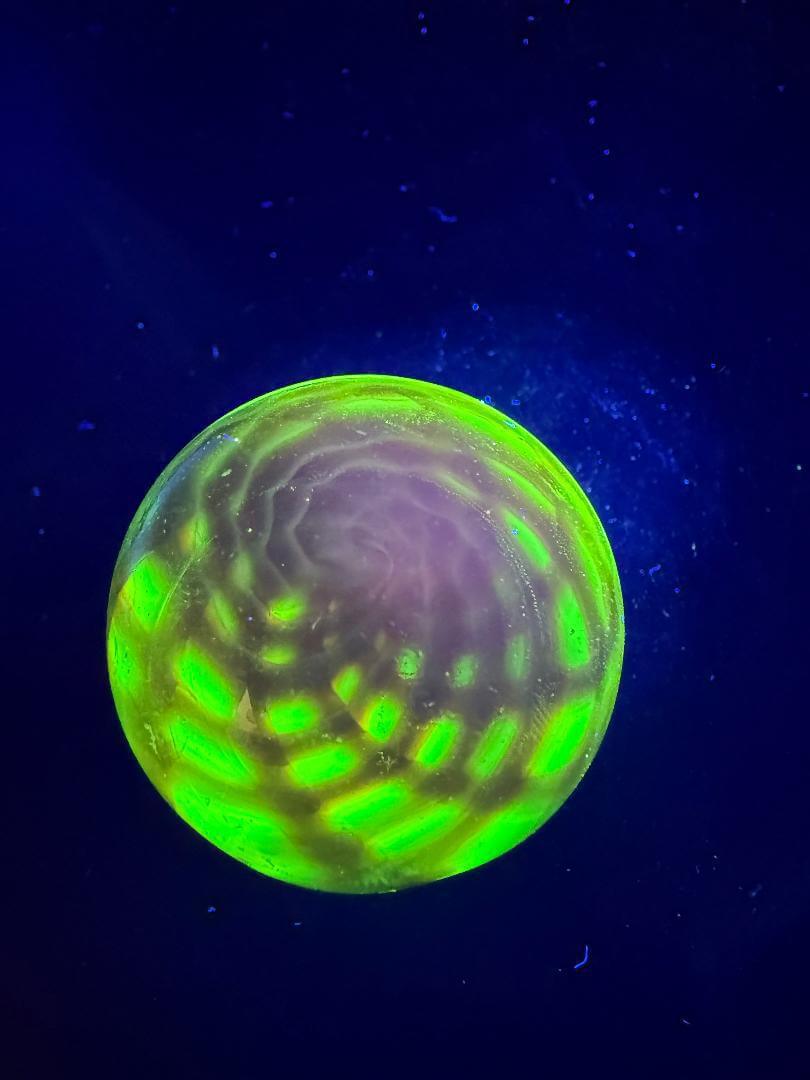 Siliceous Boro Jockey (SBJ) Marble - 42mm UV Retti Cello w/ UV Dot Stack Backer glowing under UV light.