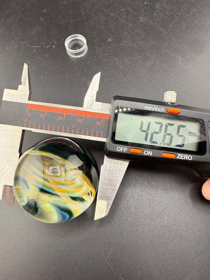 Siliceous Boro Jockey (SBJ) Marble - 42mm UV Retti Cello w/ UV Dot Stack Backer being measured at 42.66mm.