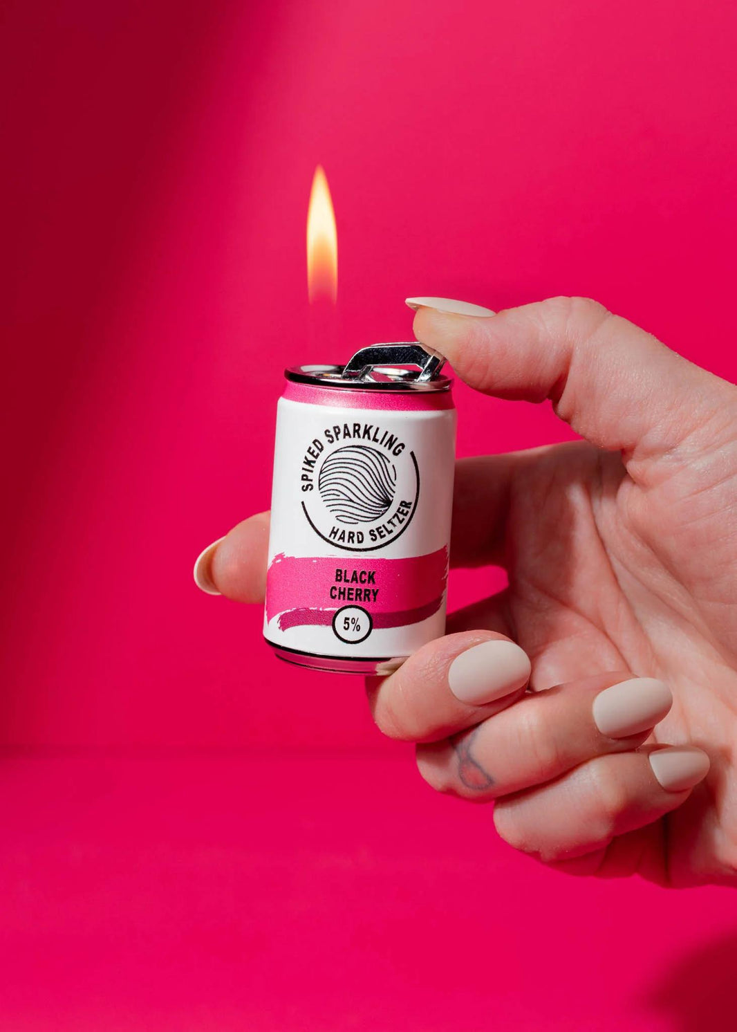 Canna Style Lighter - Spiked Seltzer in hand, designed like a mini soda can with pull-tab ignition, flame visible.