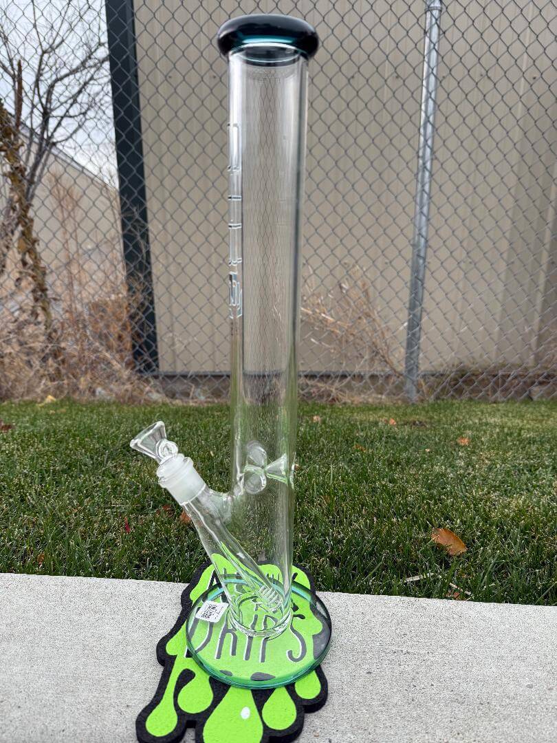 Str8 Glass 18" Straight Tube 14mm 45° displayed with a green base on grass, showcasing its sleek design and durability.