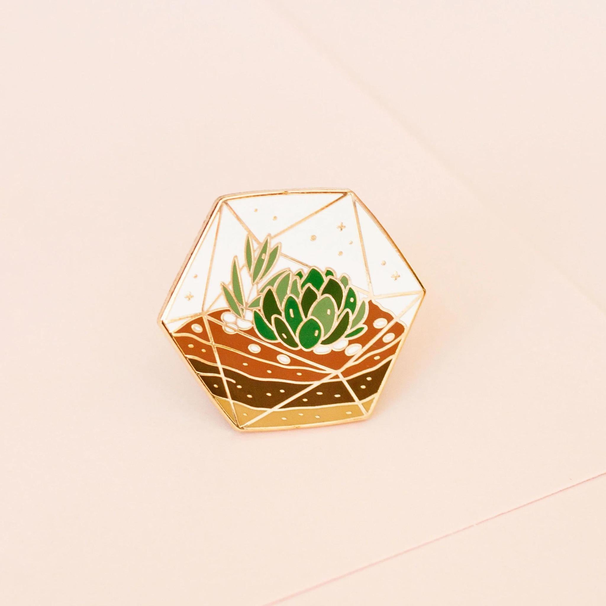 Occasionalish Enamel Pin - Succulent Terrarium featuring a colorful succulent arrangement in a faceted glass terrarium.