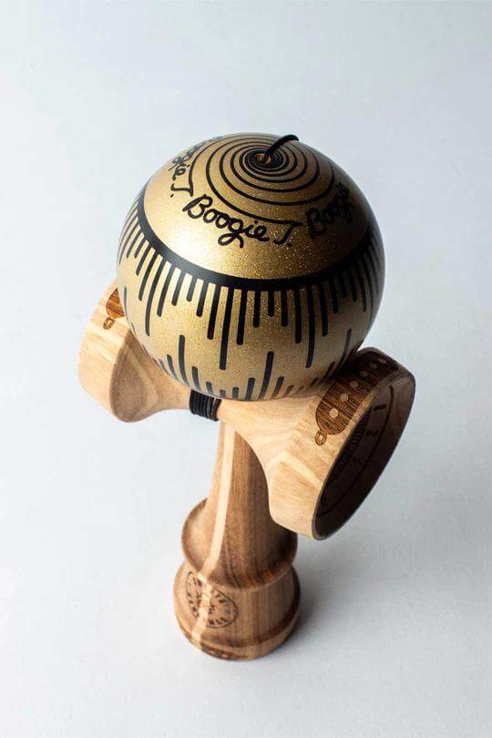 Sweets Kendama Boogie T Gold - Amped model featuring glittering gold tama and custom design on a spliced Amped ken.