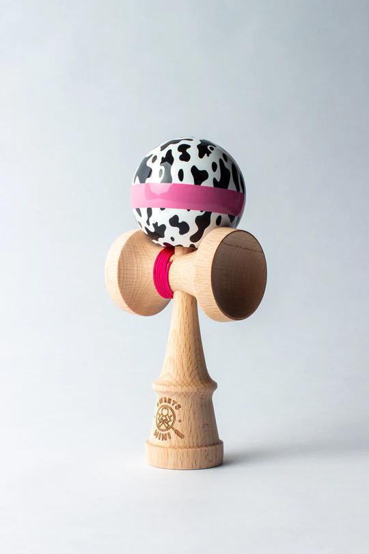 Sweets Kendama - Cow Print featuring a unique cow print design for playful tricks and portable fun.