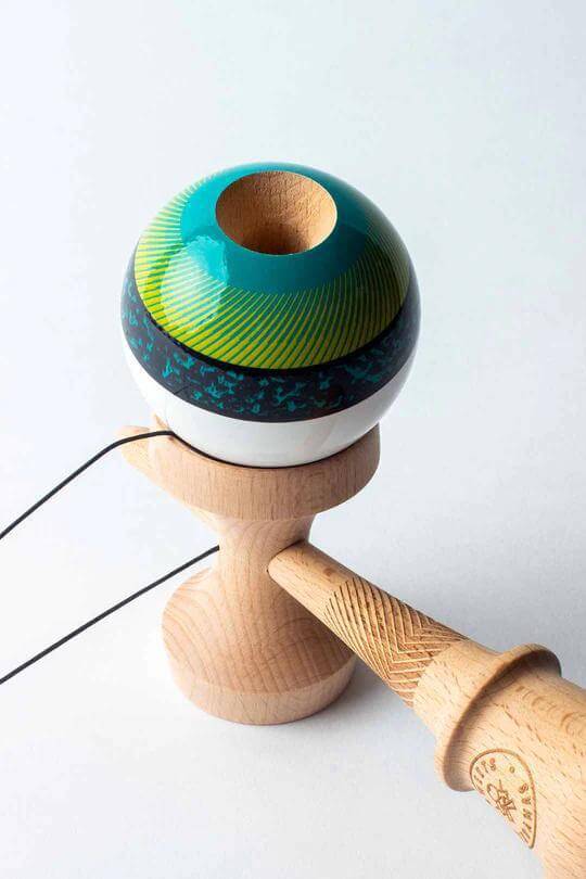 Sweets Kendama Illusion Amped with vibrant blue and green design on a white upper, showcasing full beech wood construction.