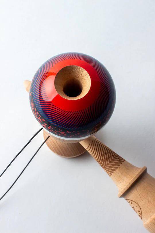 Sweets Kendama Illusion - Amped, featuring a red and blue design with beech construction for enhanced playability.
