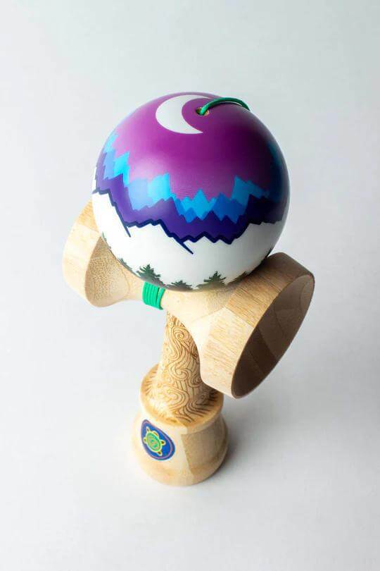 Sweets Kendama Joshua 'Flow' Grove Pro in purple and white design with natural wood base.