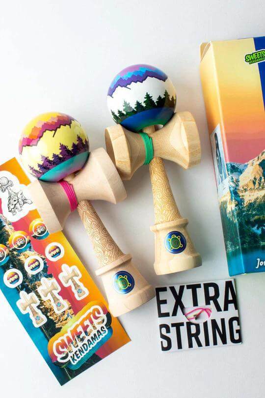 Two Sweets Kendamas featuring Joshua 'Flow' Grove Pro Mods, stickers, and extra string on a colorful background.