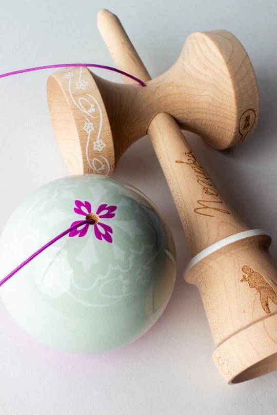 Sweets Kendama Nonoka Kyodo Amped Sticky Clear with floral design and natural wood handles.