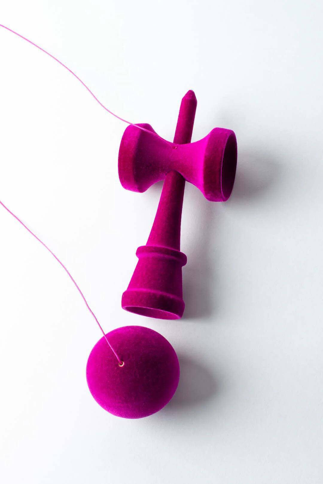 Fuzzy purple Kendama featuring velvety flocking for enhanced grip and unique design.