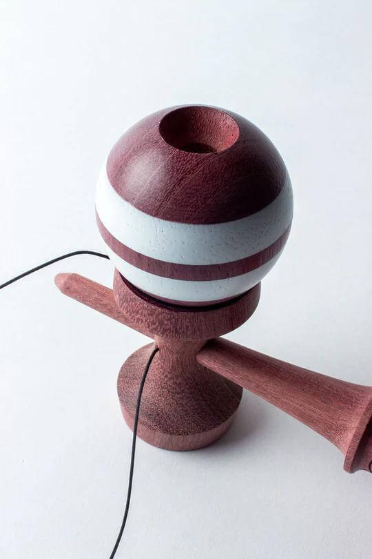 Sweets Kendama Purpleheart with hand-painted ball, featuring white stripes, KEN Amped shape, and metal spinner bead.