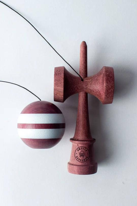 Sweets Kendama featuring Purpleheart wood, KEN Amped shape, and hand-painted 62mm tama with Cushion Clear finish.