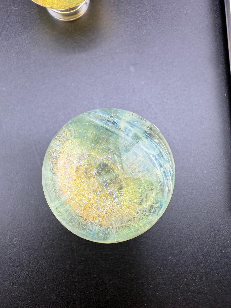 Taco Glass Marble - Fumed Dichro 1.1" featuring vibrant color-shifting effects and a striking dichroic finish.