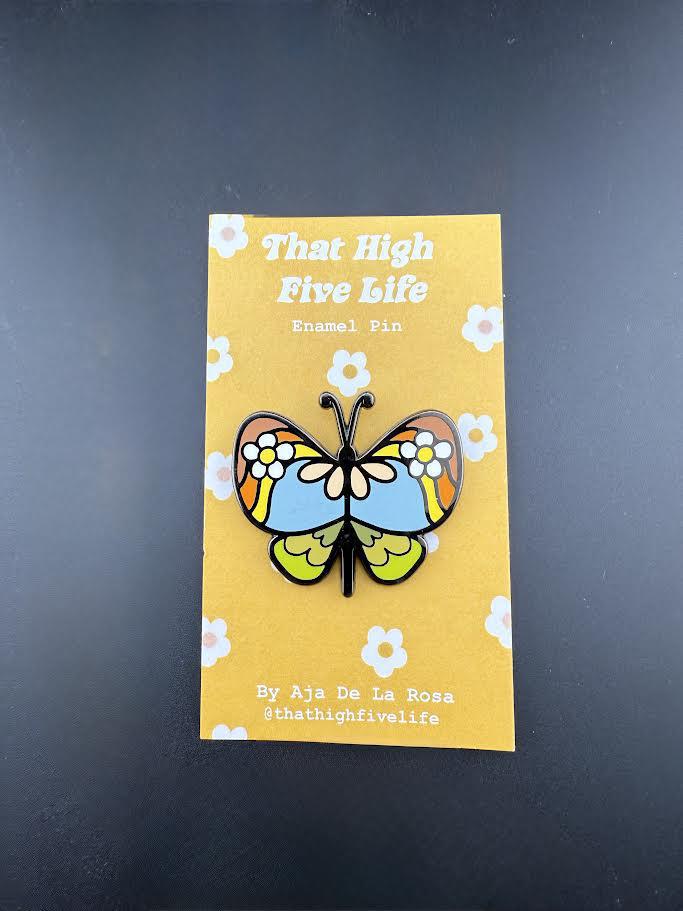 That High Five Life Enamel Pin - Funky Butterfly on a vibrant yellow backing with floral accents.