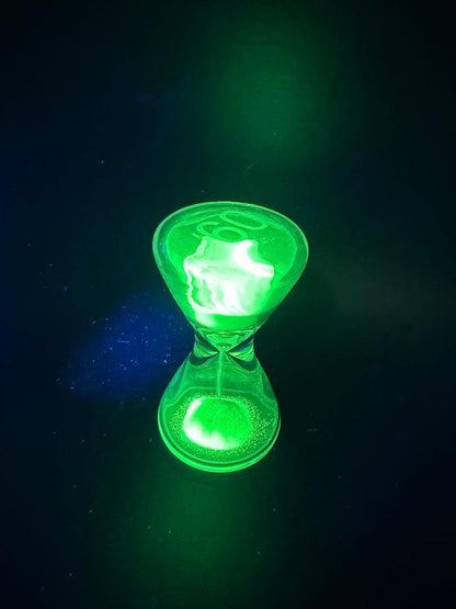Thick Ass Glass (TAG) Hour Glass - 1 Minute Timer Glow in the Dark showcased with a glowing green color.