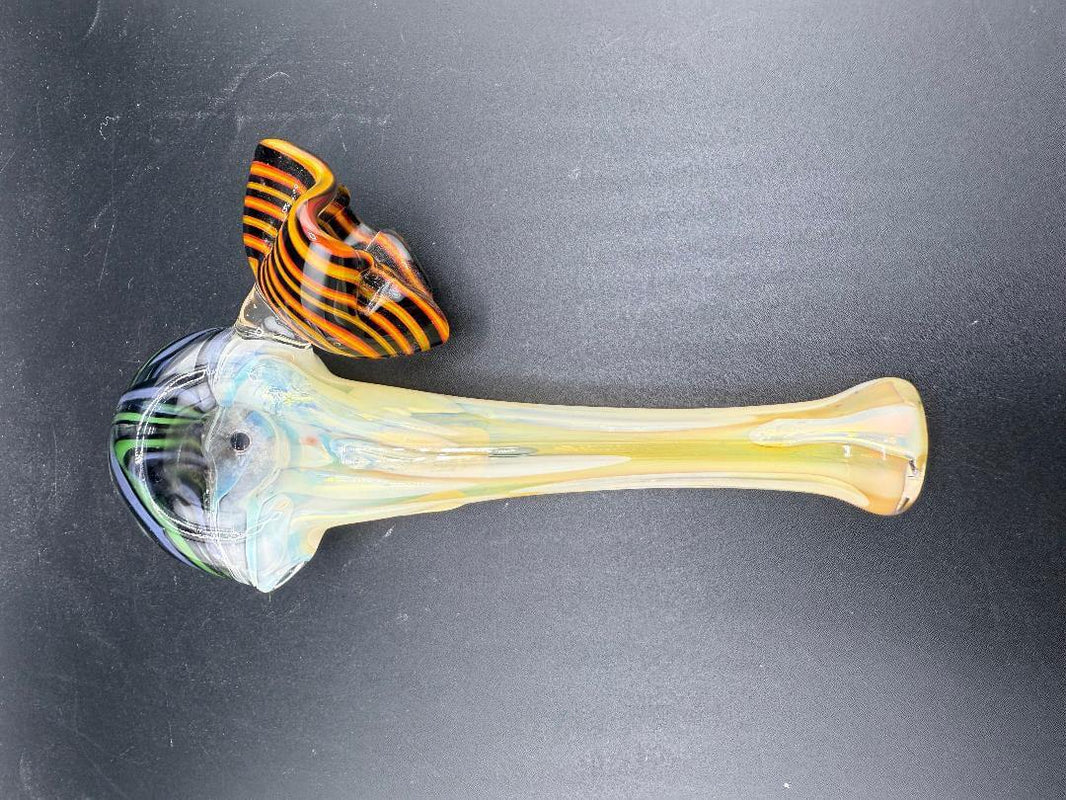 Tuck Glass Hand Pipe - Fumed w/ Wig Wag Cap & Floral Attachment on a black background.