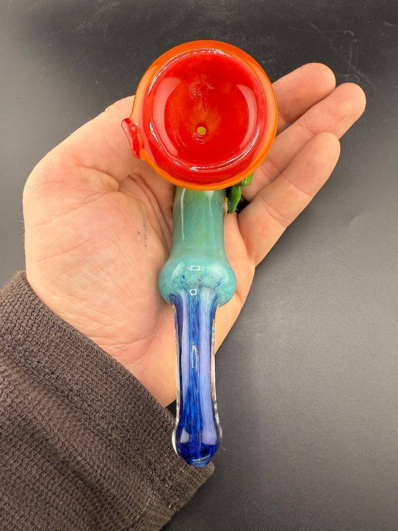 Unknown Artist Sherlock Pipe - Rainbow Frit w/ Leaf Attachment held in hand showcasing vibrant colors.