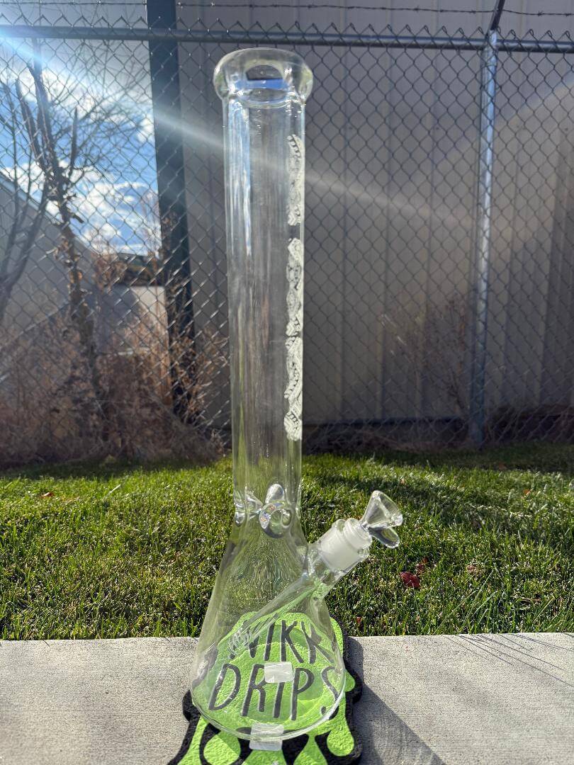 MAV Glass 18' Beaker 14mm 45° - Glow In The Dark Tribal with unique tribal design in outdoor setting.
