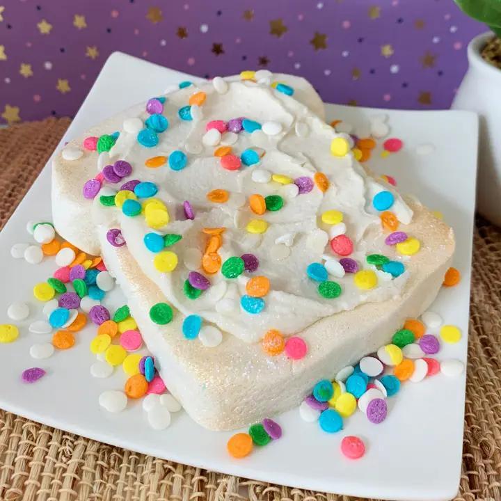 Whipped Up Wonderful Fairy Toast Bubble Bar on a plate with colorful sprinkles and icing.