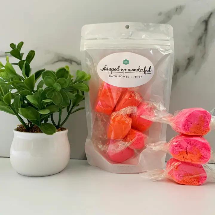 Whipped Up Wonderful Love Spell Bath Taffy in vibrant colors with a decorative plant.