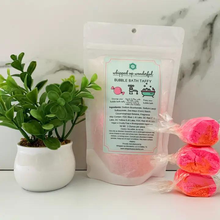 Whipped Up Wonderful Love Spell Bath Taffy in packaging with colorful bath taffy pieces and a small plant.