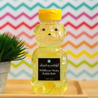 Whipped Up Wonderful Wildflower Honey Bubble Bath in a honey bear bottle with colorful background.