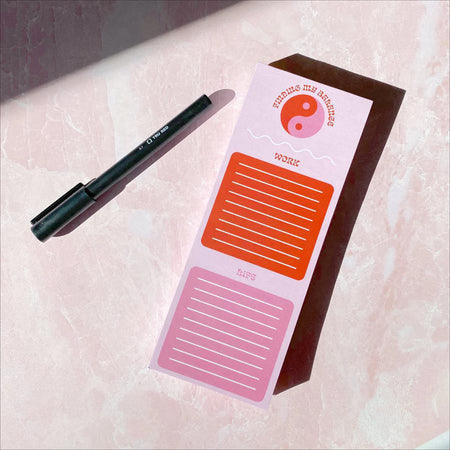 Wild Rose Notepad - Finding My Balance with pen, pink background, sections for work and life tasks.