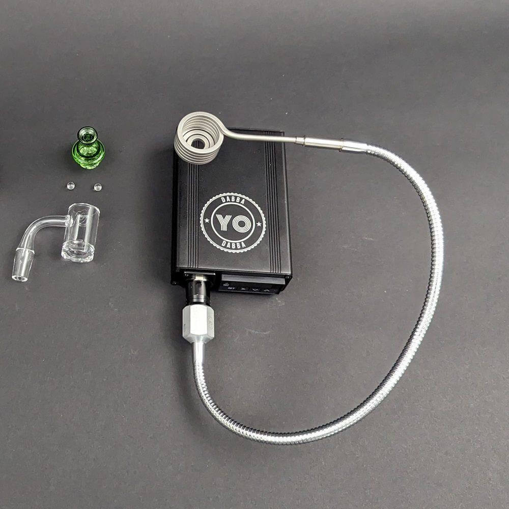 Yo Dabba Dabba Flex Coil Enail 25mm Kit with control box, quartz nail, and accessories on a black surface.