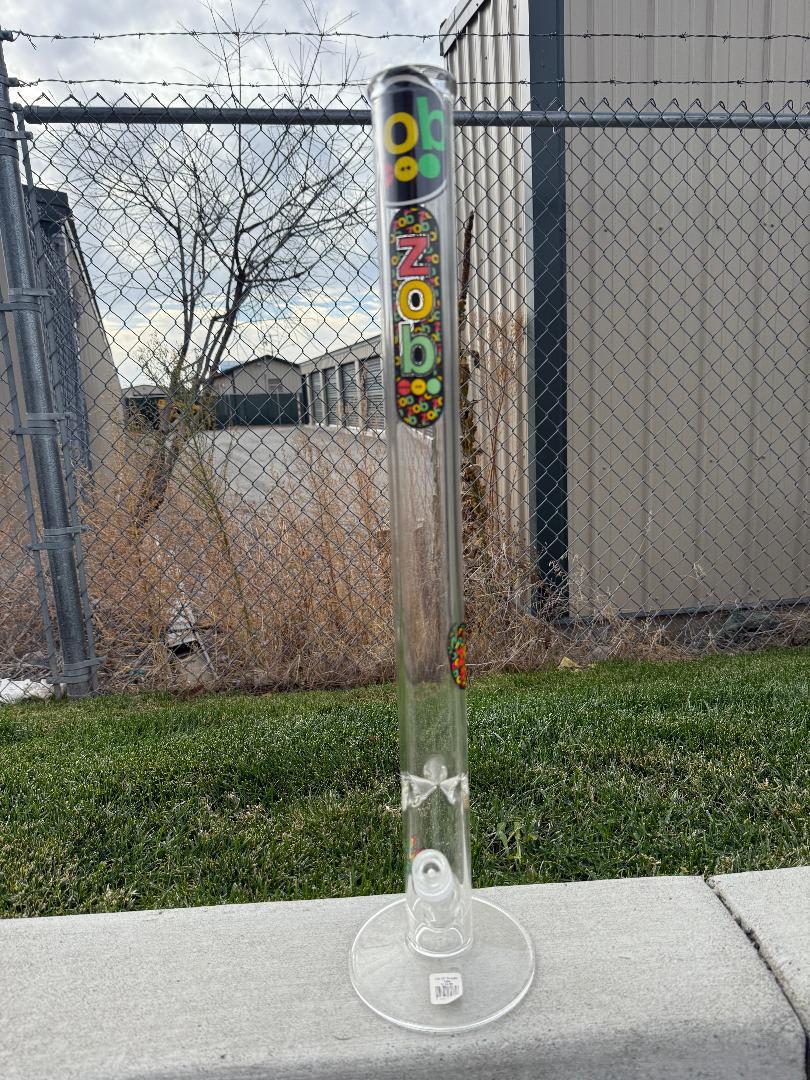 Zob Glass 24" Straight Tube Flower Piece displayed outdoors, showcasing its clean design and borosilicate glass construction.