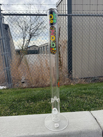 Zob Glass 24" Straight Tube Flower Piece displayed outdoors, showcasing its clean design and borosilicate glass construction.